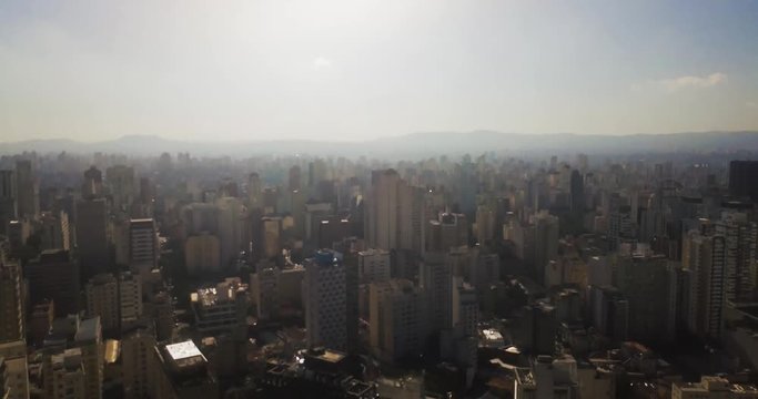 Aerial rise establishing shot of Sao Paulo on bright warm morning 4k