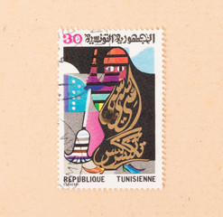 TUNISIA - CIRCA 1986: A stamp printed in Tunisia shows a woman cleaning, circa 1986