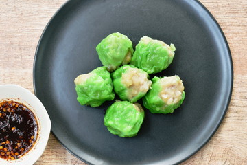 steamed Chinese jade dumpling filling minced shrimp or dim sum dipping soy sauce on plate