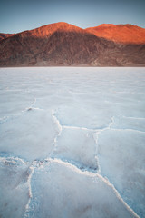 Naklejka premium View of the Basins salt flats, Badwater Basin, Death Valley, Inyo County, California, United States. Salt Badwater Formations in Death Valley National Park. Wonderful sunset. Bucket list for roadtrip.