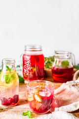 Fototapeta na wymiar Fresh red berries, mint and fruit lemonade in mason jars