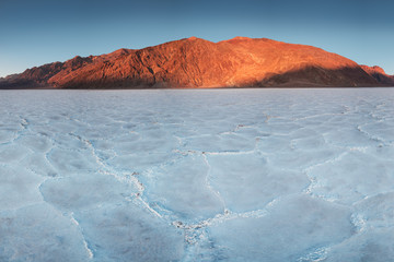 View of the Basins salt flats, Badwater Basin, Death Valley, Inyo County, California, United States. Salt Badwater Formations in Death Valley National Park. Wonderful sunset. Bucket list for roadtrip.