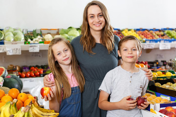 woman with kids looking for fresh delicious fruits