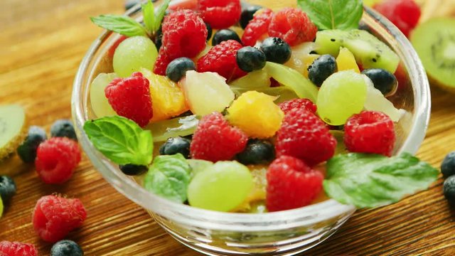 Fruit salad in bowl on table