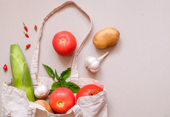Garlic, Tomatoes, Corn and Hot Peppers. Fresh organic vegetables in a textile bag. Zero waste concept