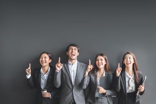 Portrait Group Of Asian Business People In Formal Suit Over Black Background