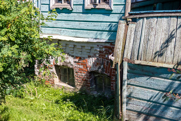 A fragment of an old house of the late 19th - early 20th century with a brick basement in the city of Borovsk, Kaluzhskiy region, Russia