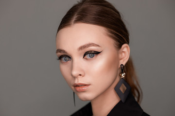 Naklejka premium Beautiful young woman with make-up in a black shirt