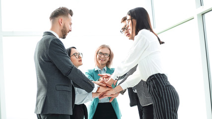 business team showing their unity while standing in the office