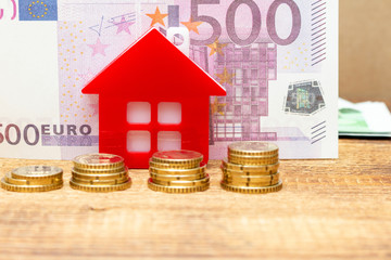 Home house on the staked coins background euro pile pack real estate concept expenses property buying mockup copy space close up background selective focus