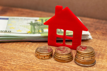 Home house on the staked coins background euro pile pack real estate concept expenses property buying mockup copy space close up background selective focus