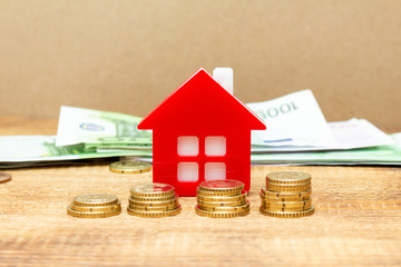 Home house on the staked coins background euro pile pack real estate concept expenses property buying mockup copy space close up background selective focus