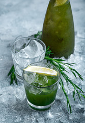 Estragon lemonade. Concept refreshing summer drinks. Fresh cool lemonade tarragon with ice and citrus slices.
