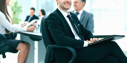 business man at office with his business team working behind