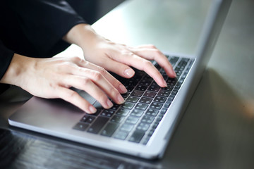 Close up of business women working with typing on laptop empty at workplace.Selective focus,business woman using laptop, searching web, browsing information
