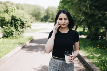 Portrait of Cute Brunette Girl in Black T-shirt in Park