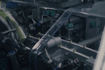 Drug Production. Medical vials on pharmaceutical manufacturing line. Medical ampoules on automated production line at factory. Process of production of pills, tablets. Pharmaceutical industry.