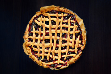 Delicious round cake on the kitchen brown table. Healthy food. Horizontal shot. Close-up