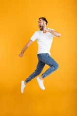 Fototapeta na wymiar Full length photo of masculine caucasian man having beard smiling and running