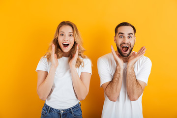 Image of excited people man and woman in basic clothing expressing surprise with open mouth