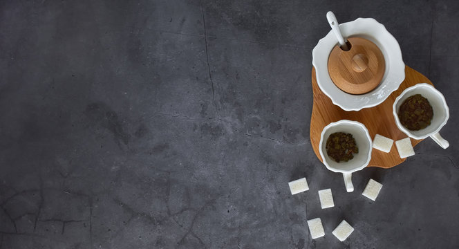 Arrangement Of Cups, Sugar Bowl And Sugar Cubes On A Neutral Gray Background From Above