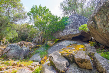Scenic landscape of green hills and rocky mountains of the island of Sardinia in spring