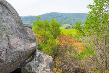 Scenic landscape of green hills and rocky mountains of the island of Sardinia in spring