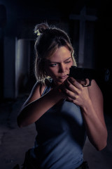 Young woman playing airsoft game in front of a camera