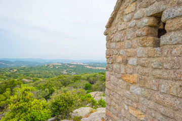 Scenic landscape of green hills and rocky mountains of the island of Sardinia in spring