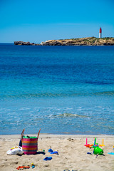 Crystal clear blue Mediterranean sea water on St.Croix Martigues beach and kids beach toys, Provence, France