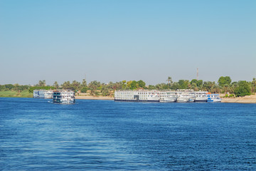 Fototapeta na wymiar Nile cruise ships leaving the quay in the vicinity of Luxor