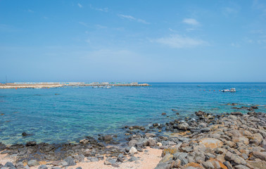 Harbor and houses of the town of Cala Gonone in Sardinia in sunlight in spring