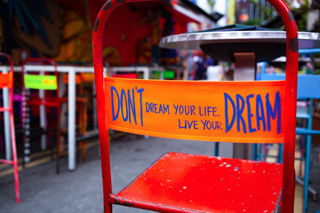 don't dream your life, live your dream - message on the back of a red chair