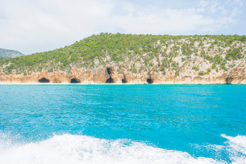 Rocky coast of the island of Sardinia in the Mediterranean Sea viewed from a boat