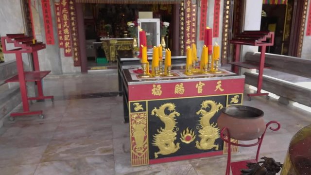 Making a merit and visit chinese shrine in Phuket,hd slow motion. Entrance of Jui tui shrine is a giant metal incense burner gum benjamin burner and big candles . 