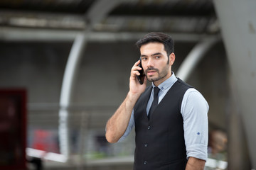 Portrait of smiling businessman with smartphone