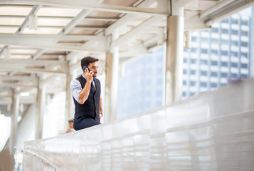 Portrait of smiling businessman with smartphone