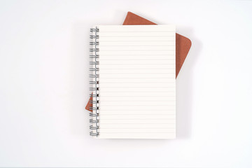 top view blank orange leather diary and pencil on white desk