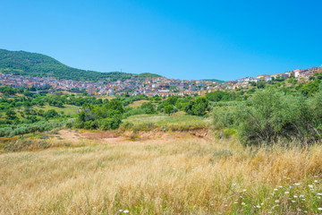 Scenic landscape of green hills and rocky mountains of the island of Sardinia in spring
