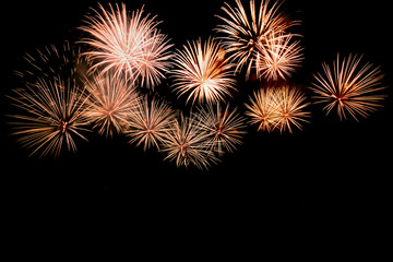 Colorful fireworks against a black night sky.Fireworks for new year. Beautiful colorful fireworks display on the urban lake for celebration on dark night background.