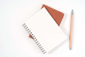 top view blank orange leather diary and pencil on white desk