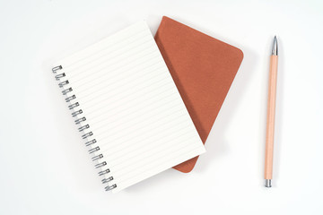 top view blank orange leather diary and pencil on white desk