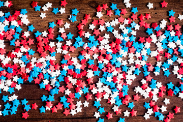 American Independence day background with blue, white and red mixed stars. Celebration of American independence day, the 4th of July (the Fourth of July). Holiday concept. Top view. With copy space. 