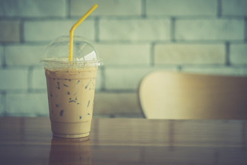 Iced espresso in glass with yellow straw