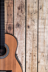 Acoustic guitar on vintage style wood background. Copy space with musical guitar instrument