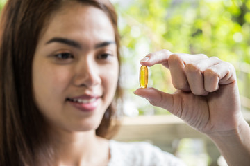 Fototapeta premium woman hand holding a pills take medicine according to the doctor's order
