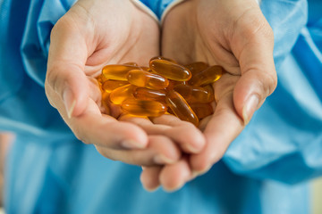 Woman's hand pours the medicine pills out of the bottle