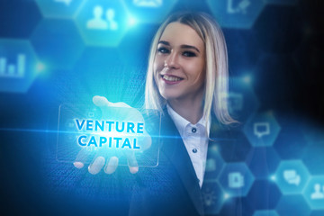 The concept of business, technology, the Internet and the network. A young entrepreneur working on a virtual screen of the future and sees the inscription: Venture capital