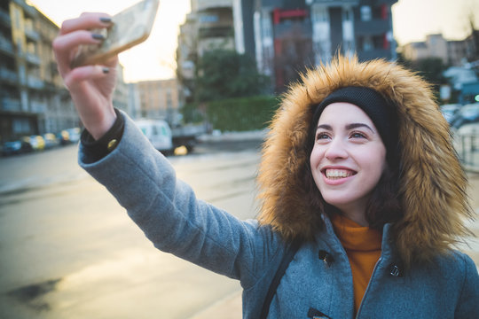 caucasian woman smiling and taking selfie