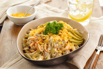 Salad of fried chicken hearts with vegetables, yolk and mayonnaise.